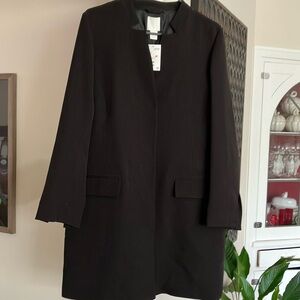 Black coat pockets in front.